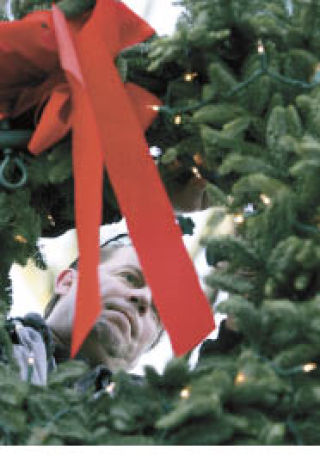 Left: Volunteer Bob Tammen helps remove holiday decorations from downtown Kirkland on Jan. 24. Right: (photo by Karen Story) Cousins Jade Gonzales