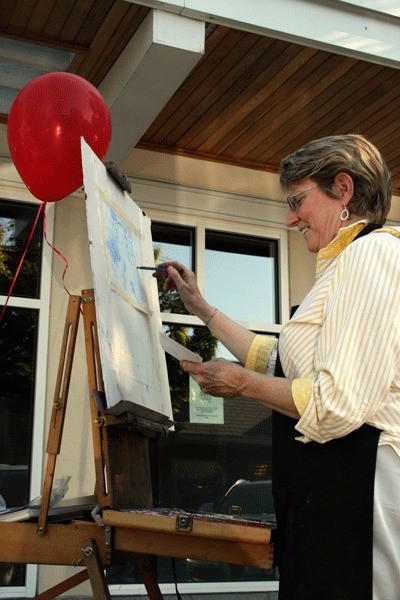 Artist Barbara Noonan creates a picture with soft pastels during Kirkland’s Second Thursday Art Walk in downtown Kirkland August 12.