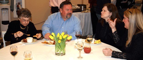 Merrill Gardens resident Sylvia Nelson (left) enjoys some appetizers with her son and daughter-in-law