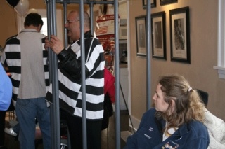 Kirkland Fire Chief Blake is 'locked-up' for the Muscular Dystrophy Association's (MDA) annual fundraiser as greeter/warden Amber Morse looks on.