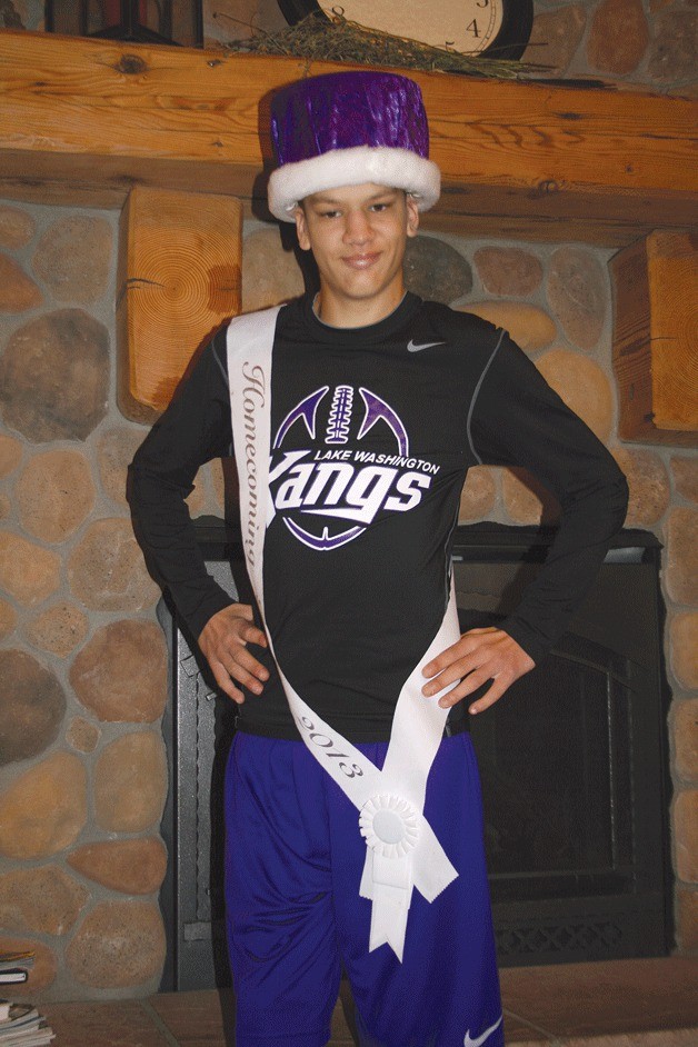 Lake Washington High School senior Tre Walker poses in regal fashion at his parent's Kirkland home. Walker was recently voted as homecoming king. Below: Walker and homecoming queen Maddie Shepard take a lap around the Lake Washington High School football field.