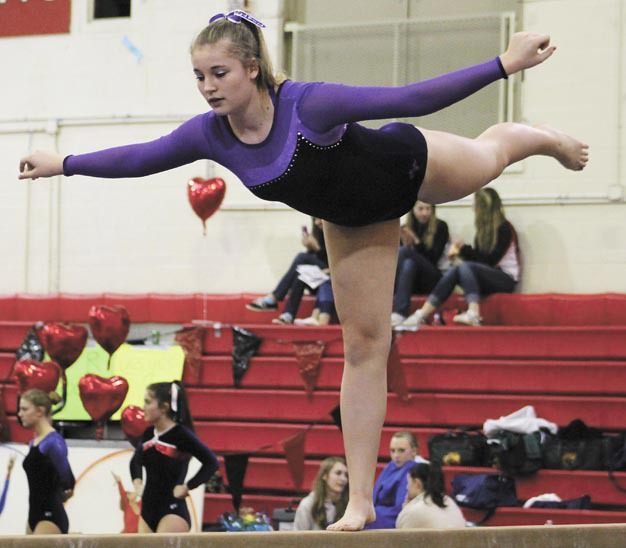 Lake Washington freshman Kiana Johnson competes on the beam during the SeaKing district gymnastics meet on Saturday