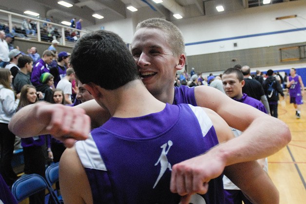 Lake Washington guard Matthew Staudacher hugs a teammate after beating Wilson during 3A state regional play at Rogers High School in Puyallup on Friday.