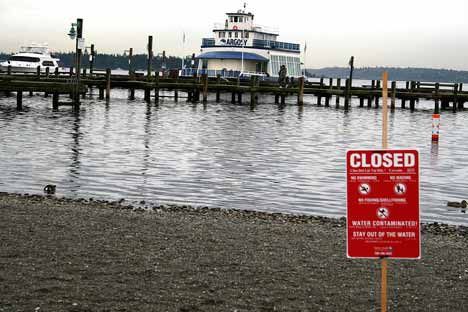 A sign at Marina Park Wednesday warns visitors that the water has been contaminated.