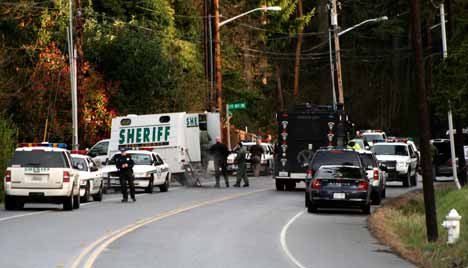 Sheriff's officers conduct an investigation and search around 11400 block of Juanita Drive Monday morning after a home invasion robbery left one suspect critically injured and the homeowner with a gunshot wound. A manhunt was underway for a second suspect.