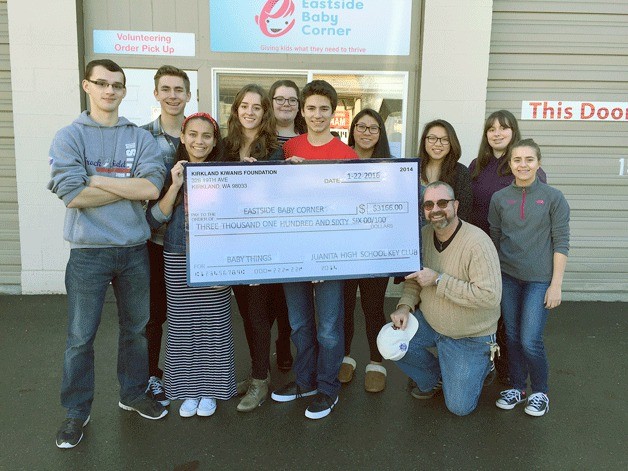 Juanita High School Key Club members present Eastside Baby Corner officials with a check for more than $3
