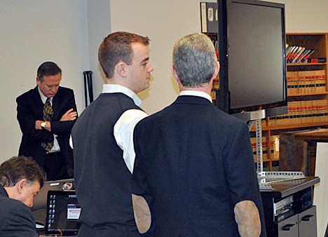 Conner Schierman consults with his attorney during court proceedings.