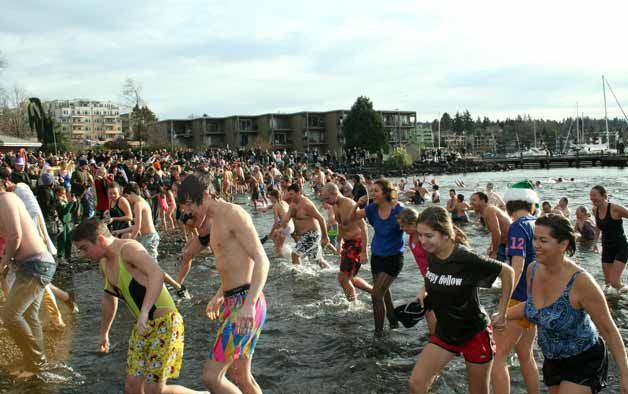 More than 100 shivering swimmers plunged into Lake Washington to ring in the new year during Kirkland's unofficial Polar Bear Plunge event at Marina Park on Sunday afternoon.