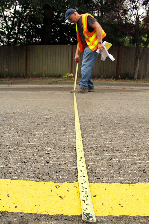 Inspector Jim Jennings measures 132nd Avenue Northeast