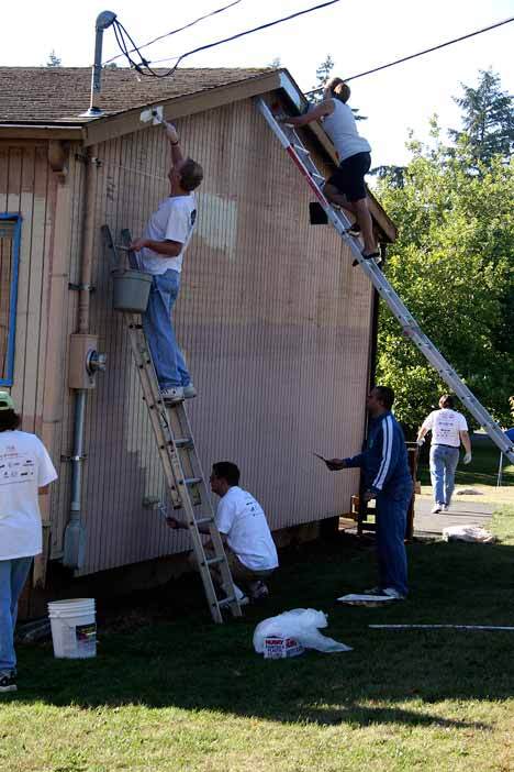 Microsoft employees participate in the company's Day of Caring by helping to paint portables at John Muir Elementary in the Kingsgate neighborhood.