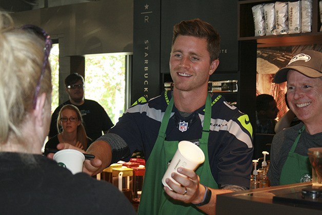 Seahawks placekicker Steven Hauschka serves coffee at the Rose Hill Starbucks to raise funds for A Better Seattle (ABS).