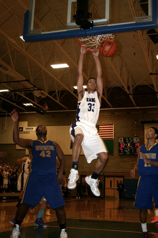 Lake Washington center Austin Glenn throws down a thunderous dunk during the Kangs romp over Bremerton Saturday night. The 87-60 win at Bothell High School sends the Lake Washington boys basketball team to the state tournament.