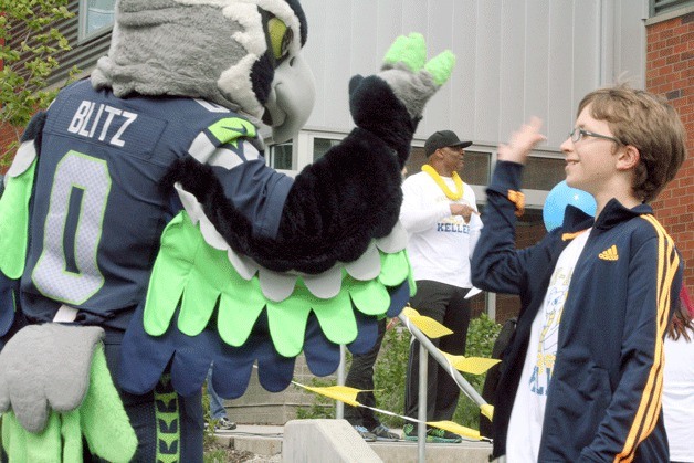 Helen Keller fifth grader Thomas Tusty high-fives Blitz