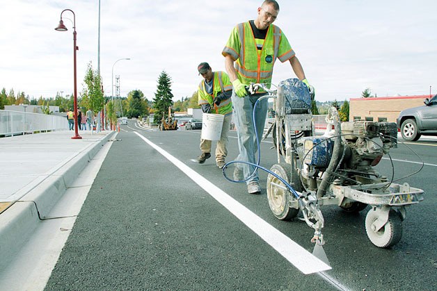 Northwest Traffic’s striper Kevin Koepke paints on Oct. 27 the eastbound bike lane on the 800-foot extension to Northeast 120th Street