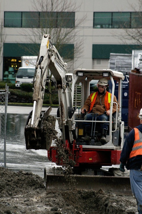 Construction workers begin laying the foundation for an addition to the south side of the Totem Lake Fred Meyer store.