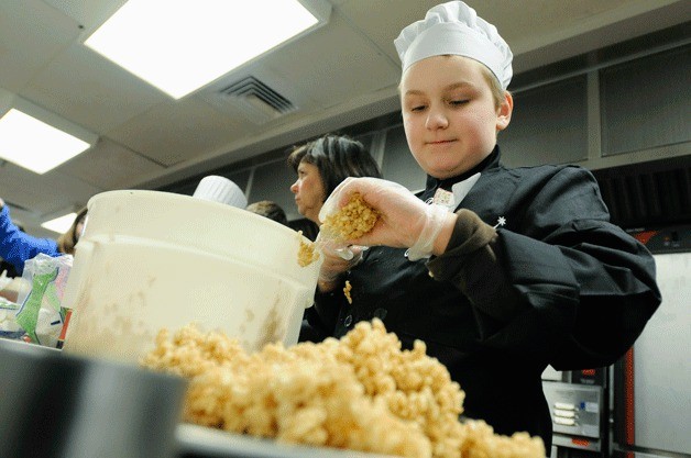 Carl Sandburg Elementary student Spencer Williams prepares “Pizza Cookies” during the Lake Washington School District’s Kids Can Cook competition at Redmond Junior High in Redmond on March 2.