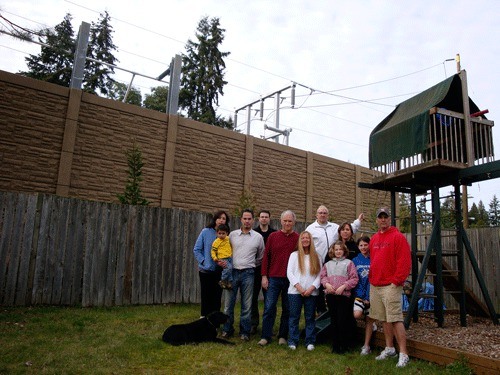 Some of the affected families stand in Michael Heslop's backyard in 2009