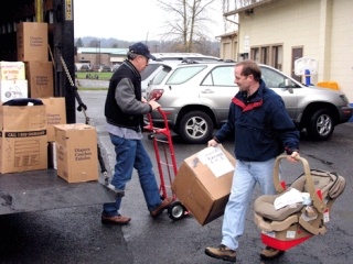 Volunteers unload diapers