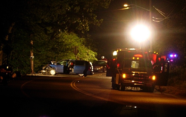 Police investigate the scene of a fatal head-on crash on Juanita Drive late Tuesday night. The blue minivan crossed the center line around 8:45 p.m.