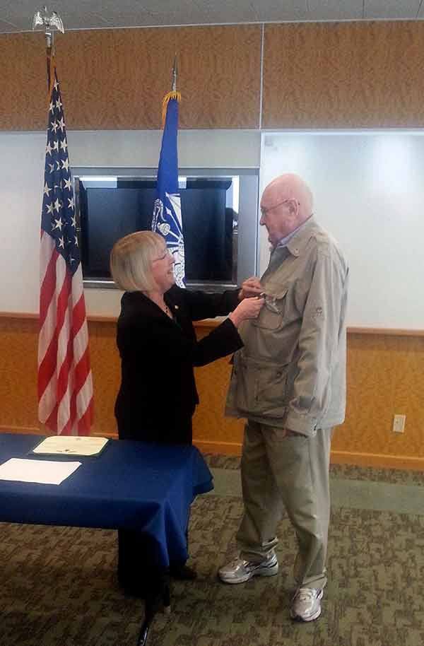 U.S. Sen. Patty Murray pins a medal onto World War II veteran and Kirkland resident Bob Gray.