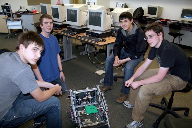 Members of the Lake Washington Robotics Club work on the robot that will compete in the 2013 VEX High School World Championship in Anaheim