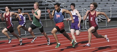 Runners in the men's 100 meter dash sprint toward the finish line during the May 6 Lake Washington School District meet at Juanita High School.