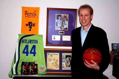 Kirkland resident Norm Vener stands with some of his 'Pistol' Pete Marvich memorabilia in his Finn Hill home.