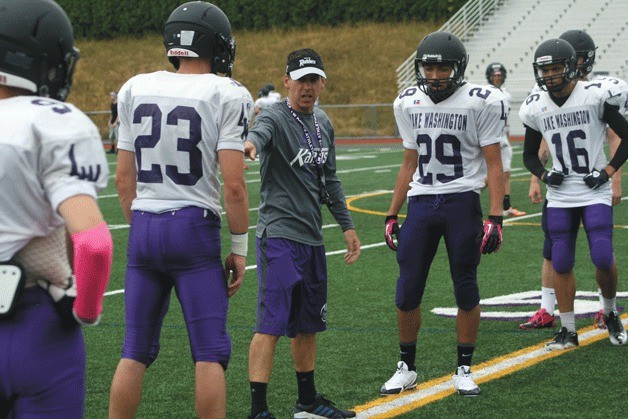 Lake Washington High School head football coach Steve Supple runs through hitting drills during a recent preseason practice.