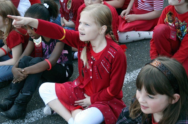 Helen Keller Elementary second grade student Ashlyn Cranmore points out a police helicopter during an anti-drug event at the school Thursday.