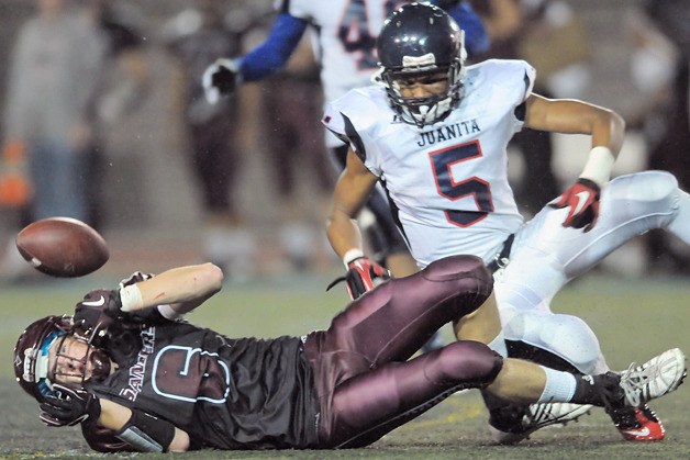 Rebels DB Andre Casino (5) puts a hard hit on Islanders WR Alex Rorem (6) and knocks the ball loose on a fourth down conversion attempt in the fourth quarter as Juanita beat the Mercer Island 28-13 at Bergh Field on Thursday.