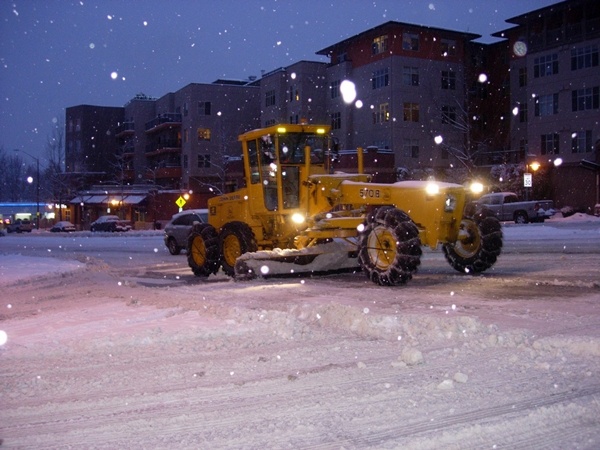 A city worker clears the intersection of N.E. 85th Street and 6th Street in downtown Kirkland Thursday night.