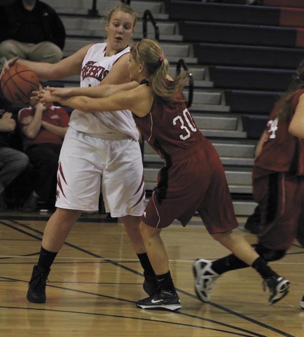 Juanita's Kate Cryderman tries to hold the basketball away from Mount Si's Katy Lindor during the Rebels win at home over the Wildcats.