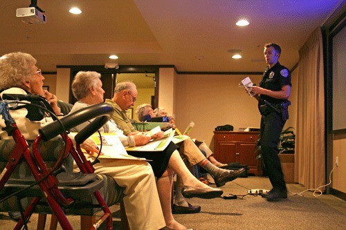Kirkland Police Officer Jon Ishmael conducts an anti-fraud education class at Merrill Gardens for Kirkland seniors.