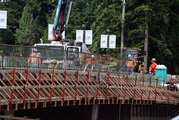 Construction workers prepare the north half of the new Northeast 116th Street bridge for a concrete pour. The bridge is being constructed in two segments to allow the street to stay open. The project includes the replacement of a bridge over the old BNSF rail line