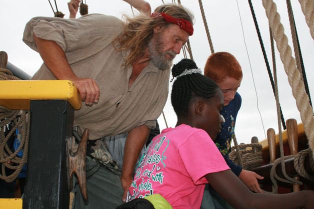 A crew member aboard the Lady Washington shows students from Buena Vista Seventh Day Adventist School from Auburn around the ship.