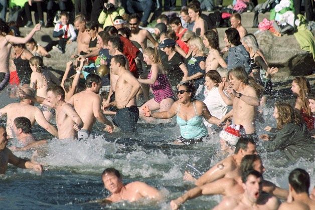Hundreds of people rush into the cold waters of Lake Washington on New Year's Day for the annual Polar Plunge at Marina Park in Kirkland.