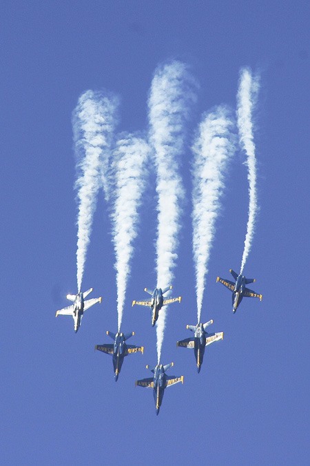 The Blue Angels turn on their smoke as they plummet back to earth for their starburst maneuver in practice on Friday