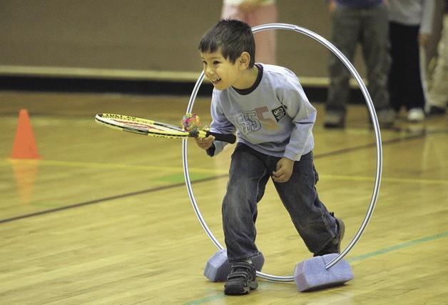 Leonardo Fisher-Alvarez makes it through an obstacle as the group works through some fun drills during a tennis class at  the Old Redmond Schoolhouse Community Center.