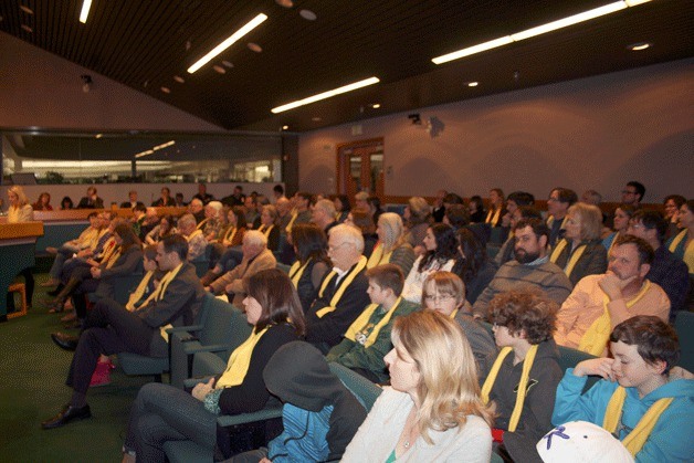 The Kirkland City Council meeting was packed full of residents during a hearing about Marijuana retail regulations in the city. Those opposed to retail on Market Street wore yellow scarves in solidarity.