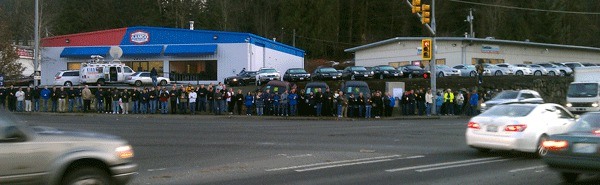 Friends and family of Bradley Nakatani stand vigil Friday afternoon at the intersection of Northeast 124th Street and 132nd Avenue Northeast