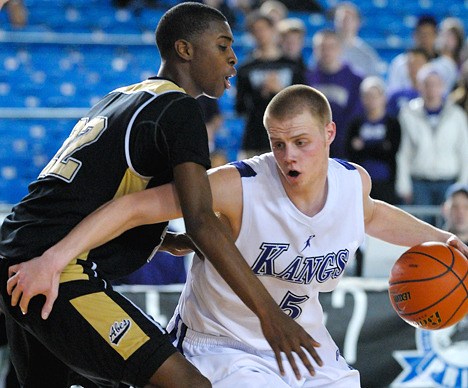 Lake Washington senior Ryan Guisness drives to the hoop against his opponent during the state tournament in the Tacoma Dome Thursday.