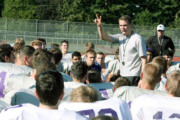 New Kang head coach AJ Parnell addresses his players following a preseason workout.