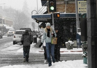 Pedestrians cross the intersection of Lake Street and Kirkland Avenue during the snow storm Dec. 18.