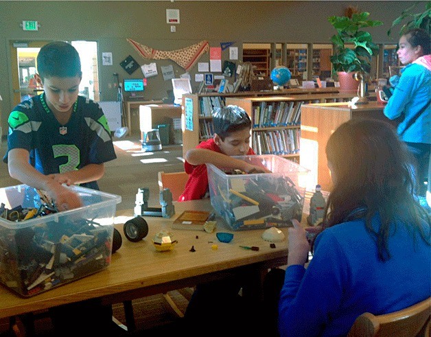 Finn Hill Middle School students work in the library with supplies purchased with funds from the Kirkland Youth Council.