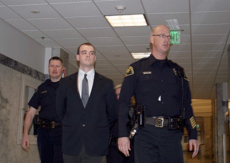 Conner Schierman (center) is escorted to the courtroom at the King County Courthouse Wednesday. The Bellevue native is accused of four counts of aggravated first-degree murder of four Kirkland family members.