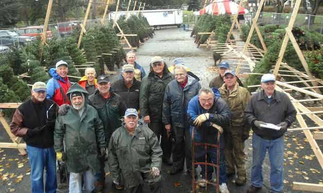 Kiwanis Club of Kirkland members in the parking lot at Juanita Beach Park where the club's annual tree lot was set up in December. Proceeds from the tree sale will benefit the local community.