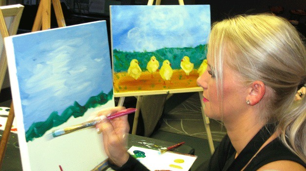 Amanda Seward instructs participants on how to paint the background of a painting during a recent session at Palettes and Pairings.
