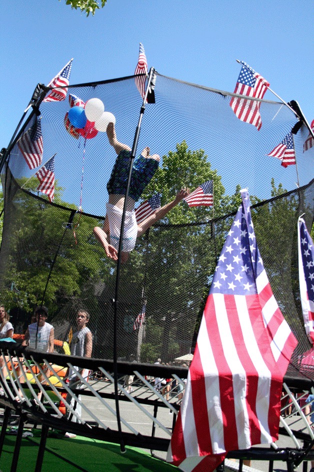 A Kirkland youngster does a backflip inside a trampoline that was set up for the Fourth of July parade in downtown Kirkland.