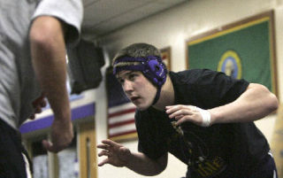Lake Washington senior Grant Haschak wrestles with his brother Sean Haschak during a team practice at LWHS on Wed.