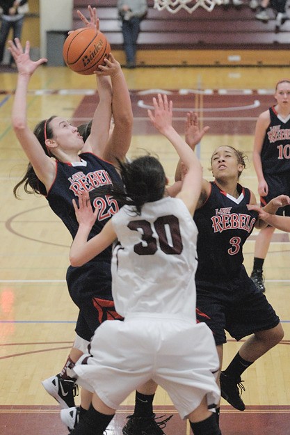 Rebels Molly Grager (25) grabs a rebound against the Islanders during the first half at Mercer Island on Friday. Juanita won 51-31.